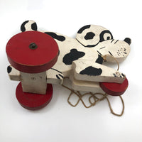 Black and White Dog on Red Wheels Old Wooden Pull Toy