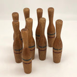 Nine Wooden Toy Skittles Pins With Red and Blue Painted Stripes