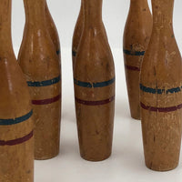 Nine Wooden Toy Skittles Pins With Red and Blue Painted Stripes