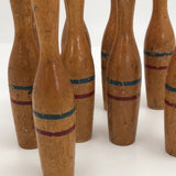 Nine Wooden Toy Skittles Pins With Red and Blue Painted Stripes