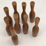 Nine Wooden Toy Skittles Pins With Red and Blue Painted Stripes