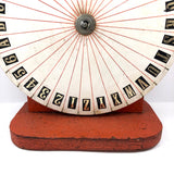 Spinning Orange and White Carnival Wheel of Chance, A-Z Plus 1-6