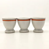 Set of Three French Porcelain Egg Cups with Orange Banding