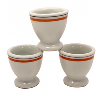 Set of Three French Porcelain Egg Cups with Orange Banding