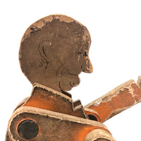 Another Jointed Wooden Man in Orange Top Coat with Wing-like Tails