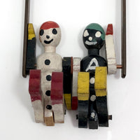 Black and White Pair of Jointed Wooden Figures on Hanger