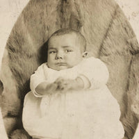 Wary Looking Baby on Fur,  Real Photo Postcard