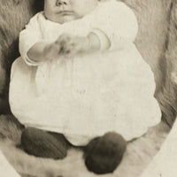 Wary Looking Baby on Fur,  Real Photo Postcard
