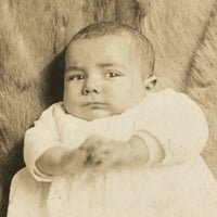 Wary Looking Baby on Fur,  Real Photo Postcard