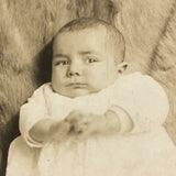 Wary Looking Baby on Fur,  Real Photo Postcard