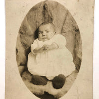 Wary Looking Baby on Fur,  Real Photo Postcard