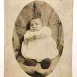 Wary Looking Baby on Fur,  Real Photo Postcard